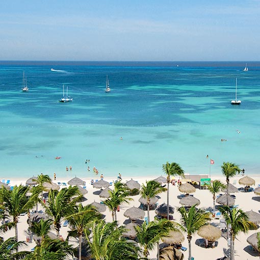 Aerial view of Marriott's Aruba Surf Club's beach and ocean access on a sunny day